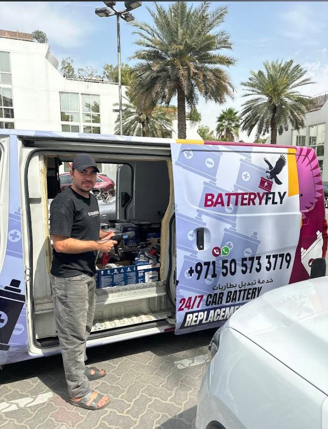 Muhammad Nabi – Batteryfly founder and car battery technician Dubai, standing with service van