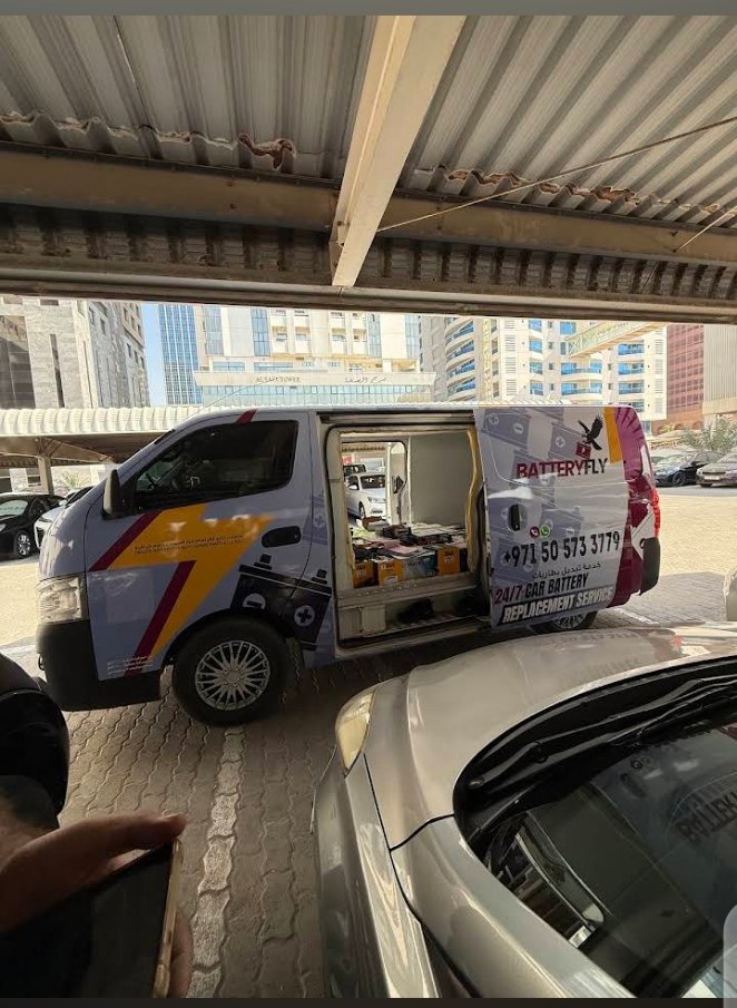 Batteryfly mobile van stocked with car batteries Dubai – open doors showing battery stock